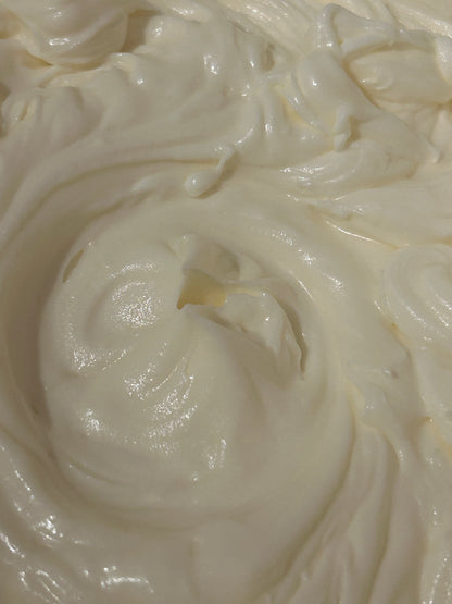 Close-up of creamy white whipped body butter with a swirl pattern
